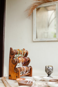 a lot of different beads on a rustic wooden table.