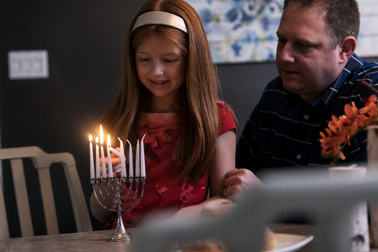 Hanukkah: Young Girl Lights Hanukkah Candles