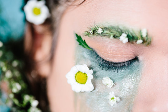 Decorative spring make up with 'garden' eyebrow look and flowers