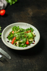 salad vegetables - tomato, lettuce, cheese, microgreen and salad dressing. food background. top