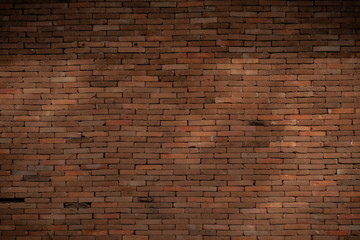 Fototapeta na wymiar dimly lit old brick wall.