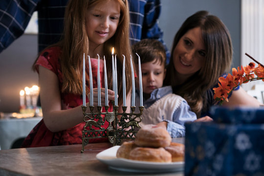 Hanukkah: Family Lighting Menorah For Holiday