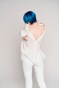 Blue haired young attractive woman undressing