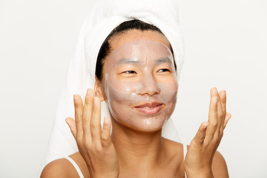 Young asian woman using facial gel mask