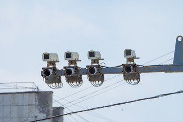 Modern speed control camera close-up on the background blue sky.