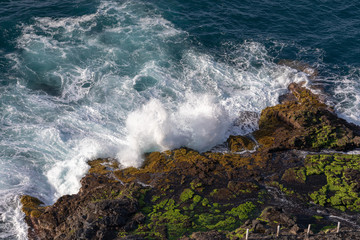 Big waves breaking on the shore with sea foam