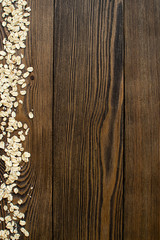 Old wooden background with decoration from oatmeal flakes