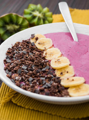 Yogurt plate with fruit and chocolate.