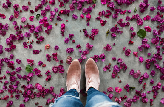 woman standing among bougainvillea petals