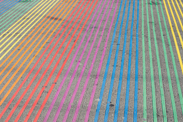Rainbow LGBT Pride sign painted on road.