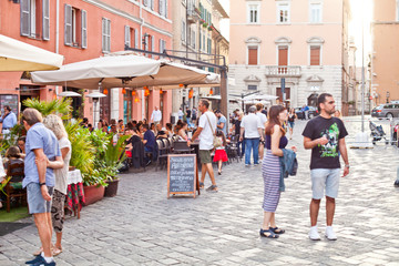 Ancona, Italy - June 8 2019: People enjoying summer day and food at outdoor restaurant and resting.