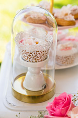dessert table with flowers and cupcakes for maternity event 