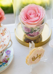 dessert table with flowers and cupcakes for maternity event 