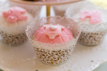 dessert table with flowers and cupcakes for maternity event 
