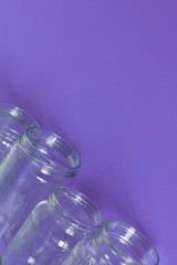 4 glass jars on a purple background with room for text