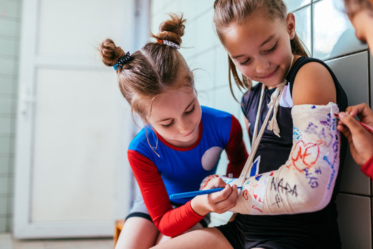 Girls sign plaster cast on a broken arm
