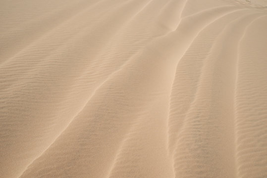 Abstract background of wind waves on dunes at desert.