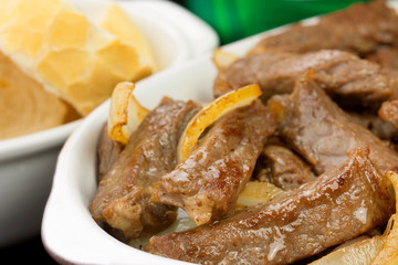 Traditional Brazilian pub food striploin with onions close