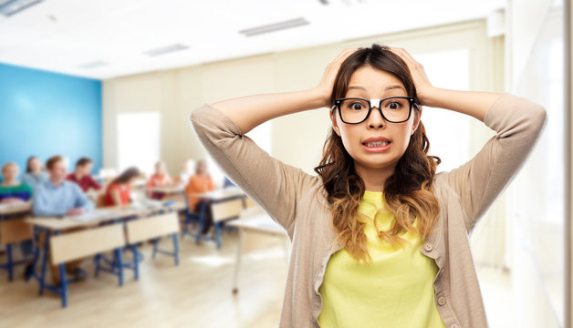 school, education and stress concept - asian woman or student in glasses fixed by tape holding to her head over classroom background