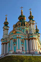 Fototapeta na wymiar Beautiful landscape photo of charming ancient Saint Andrew Church in baroque style. Vibrant blue sky at the background. Kyiv, Ukraine