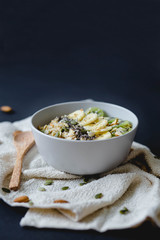 healthy breakfast of oatmeal with banana, kiwi on a white napkin and almond