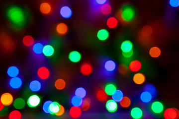 Defocused abstract christmas background of multi-colored light bulbs.