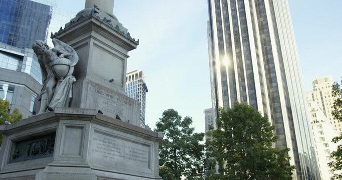 Christopher Columbus Monument In New York City, Manhattan. Famous Statue In NYC. Birds Flying Past And Landing On Statue On A Lovely Sunny Day 