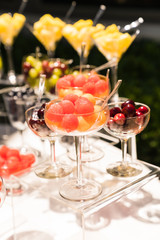 spring / summer appetizer table with fresh fruit cocktails 