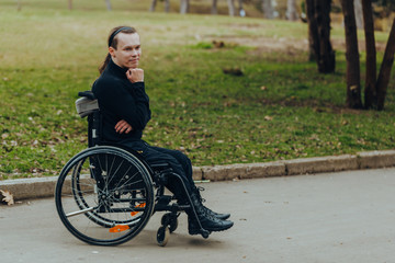 Portrait of a happy man on a wheelchair in a park