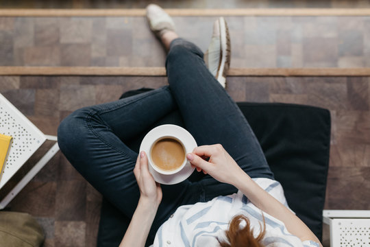 Brunette businesswoman drinking a coffee in a cooperative space