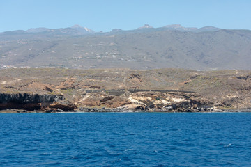 Beautiful rocks at beach with waves and blue water in Teneriffa