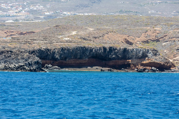 Beautiful rocks at beach with waves and blue water in Teneriffa