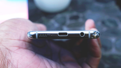 usb charging port, Prise jack, speakers, microphone, on the bottom of a smartphone, Closeup