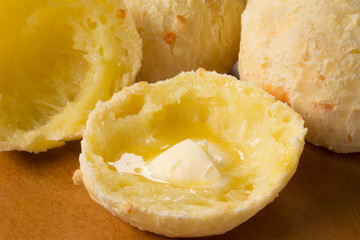 Cut traditional Brazilian snack cheese bread with melted butter