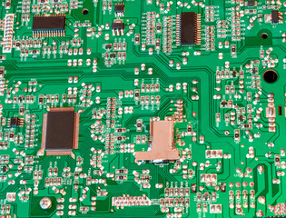 Green electronic board with microcircuits close up