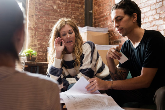 Coworkers meeting and talking about design of paper