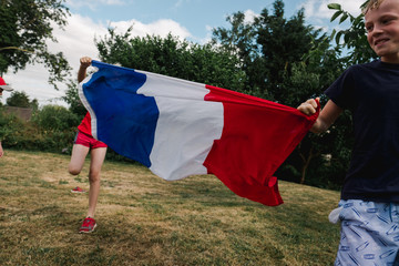 little boys running with a  flag from France before world cup soccer / football game