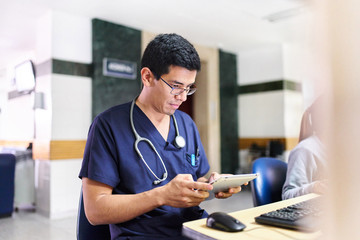 Young male doctor with a tablet