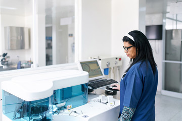 Lab professional with analyzer machine