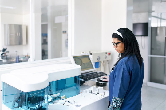 Lab professional with analyzer machine