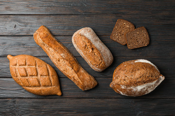 Flat lay composition with bakery products on wooden background, top view and space for text