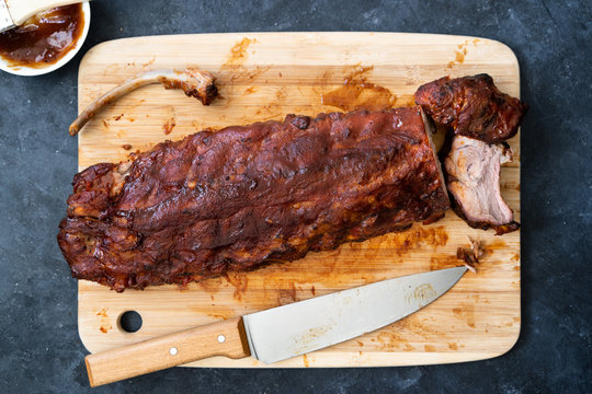 Delicious pork ribs cooked over a barbecue and covered in bbq sauce.