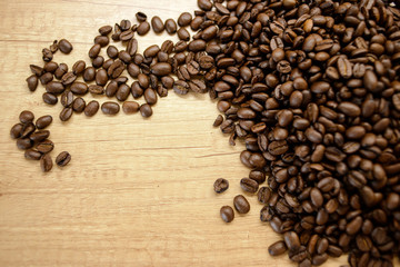 Roasted coffee beans on rustic wooden table background