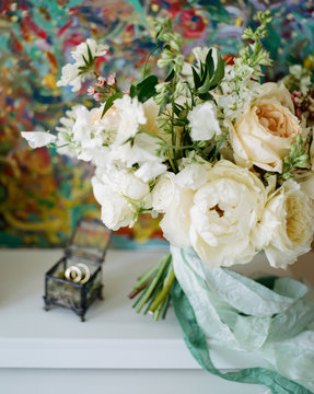Bouquet near wedding rings