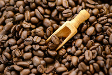 Roasted coffee beans on rustic wooden table background