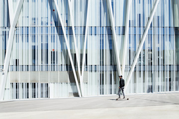 Skater on street with modern architecture