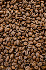 Roasted coffee beans on rustic wooden table background