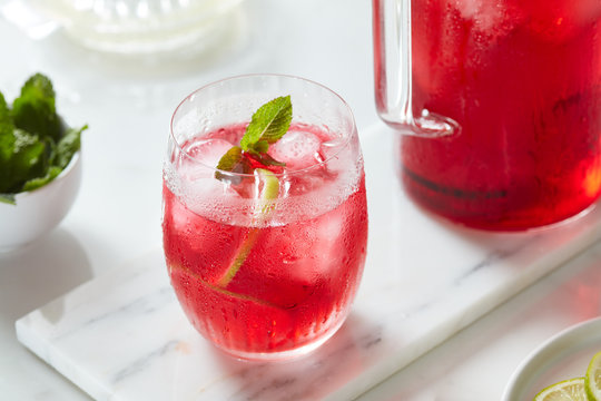 Glass of Jamaican infusion with mint on top.