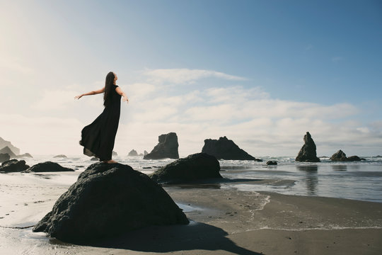 Woman Standing by Ocean