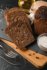 Composition with bread on cutting board, closeup and space for text